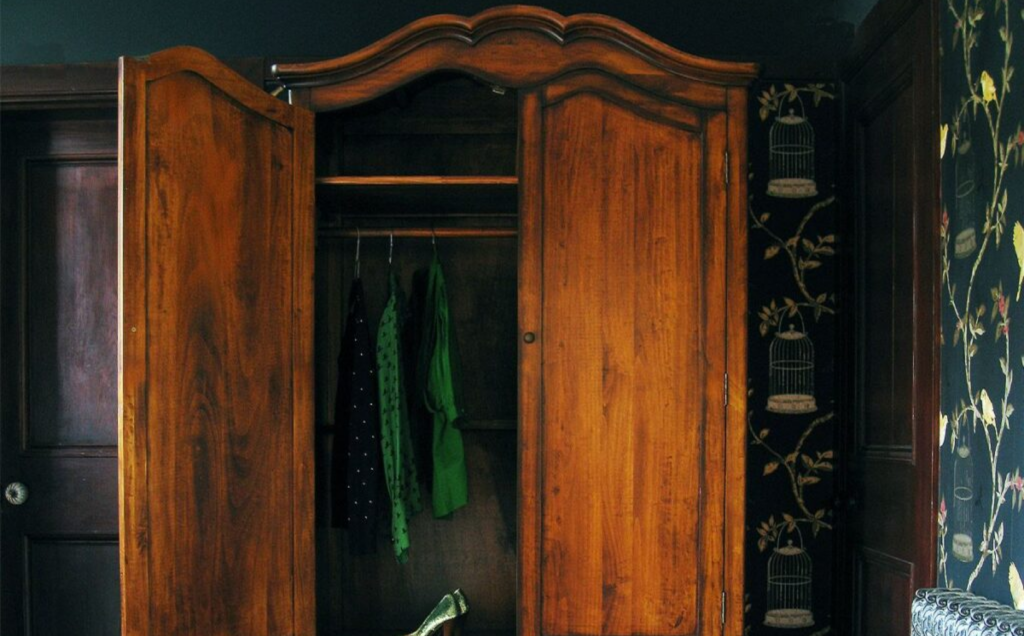 wardrobe with green clothes hanging